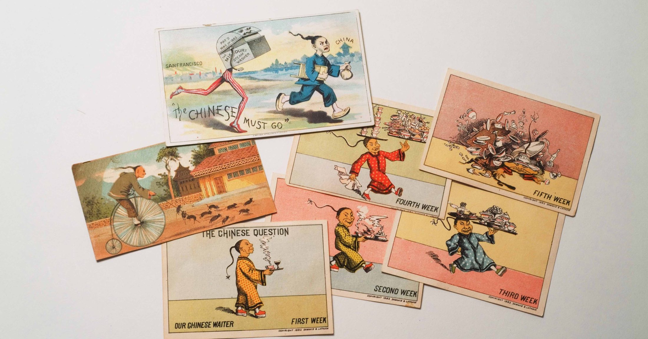 A photograph of trade cards featuring stereotypical images of Asians from the Yoshio Kishi Collection.