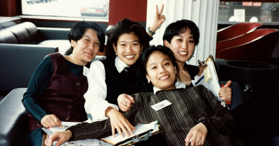 Members of the Asian/Pacific/American Institute sitting next to each other and posing for a photo.