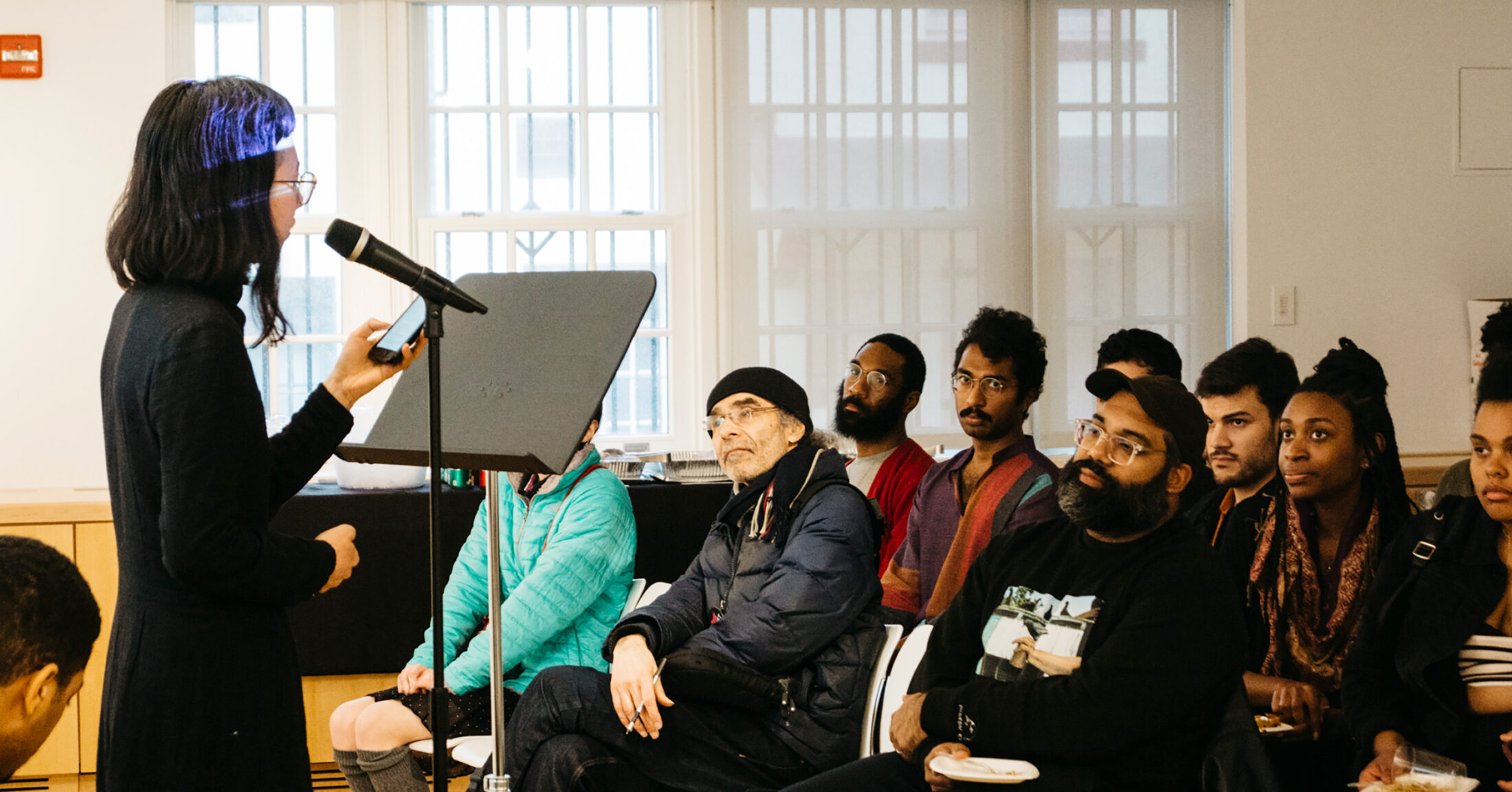 A speaker speaking to an audience for "Labor of Love"