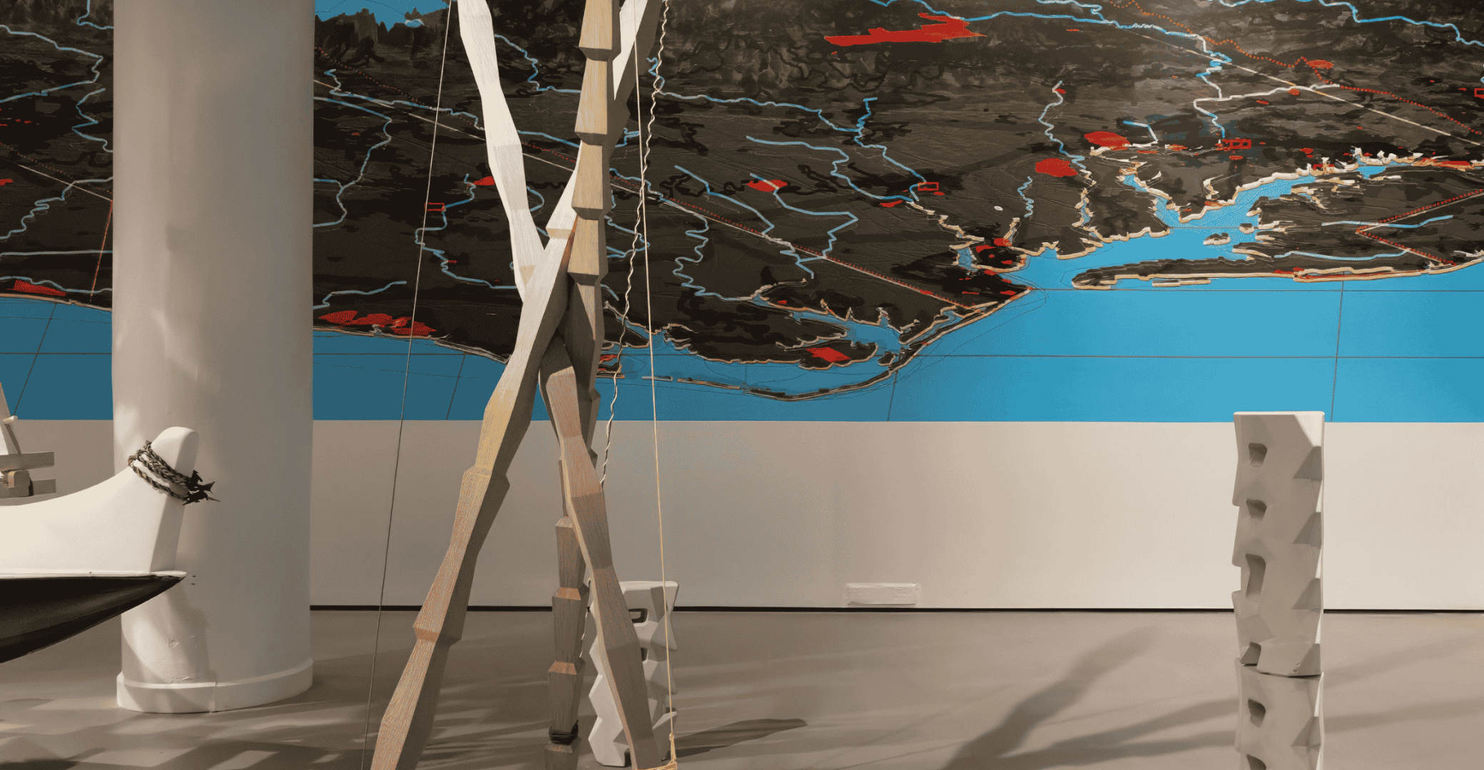 A photograph of the installation, Hawai'i is not the US but it is your Future, by Sean Connelly. The photograph features sculpture and mapping work by Connelly.