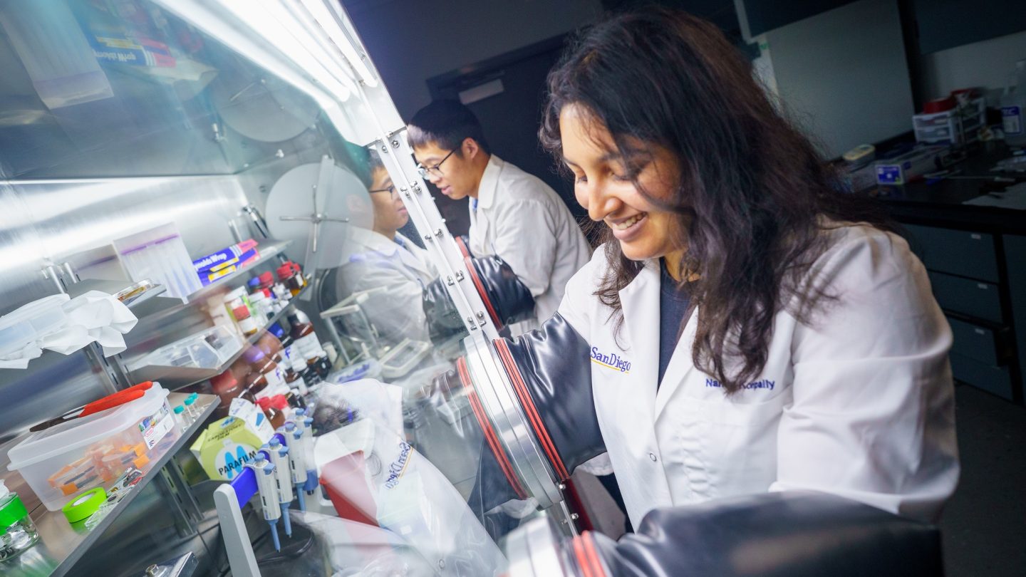 A photograph of two UC San Diego engineers working with a new structural supercapacitor.