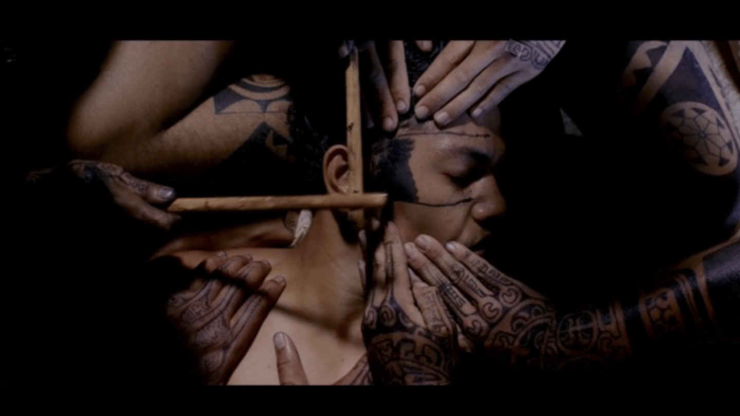 A still from the Patutiki: The Guardians of the Marquesan Tattoo. It shows a tattoo in process.