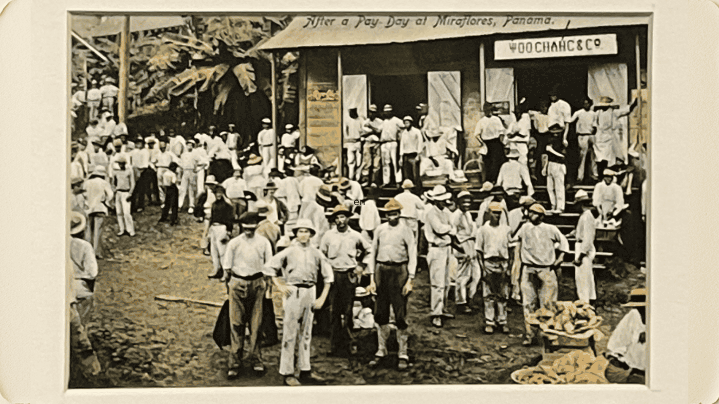 This archival photograph depicts Caribbean workers visiting a Chinese shop, Woo Chang & Co., one of many that lined the greater Canal Zone.